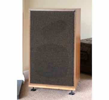 Goodman's Magnum SL loudspeakers in place within a room. These loudspeakers use an infinite baffle system with a bass 12 inch woofer, mid frequency range squawker, and top frequency range tweeter