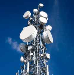 A variety of microwave parabolic reflector antennas mounted on a mobile phone / cellular tower
