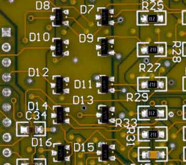 Series of SMT diodes on a printed circuit board.
