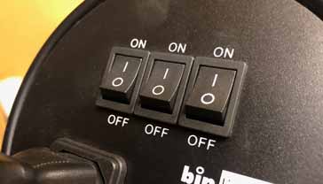 Bank of three rocker switches on an item of electronics equipment
